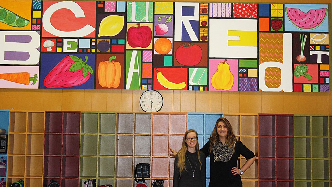 C'est l''artiste Mélanie Guénette (à gauche) qui a réalisé la toile murale. Sur la photo, elle est accompagnée de l'enseignante Audrey Jacques.