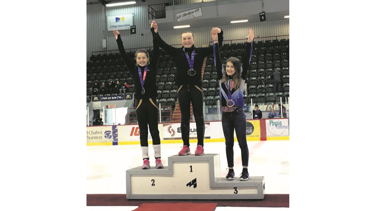 Amelia Duchesne Blinn au centre du podium lors de la remise de sa médaille d’or.