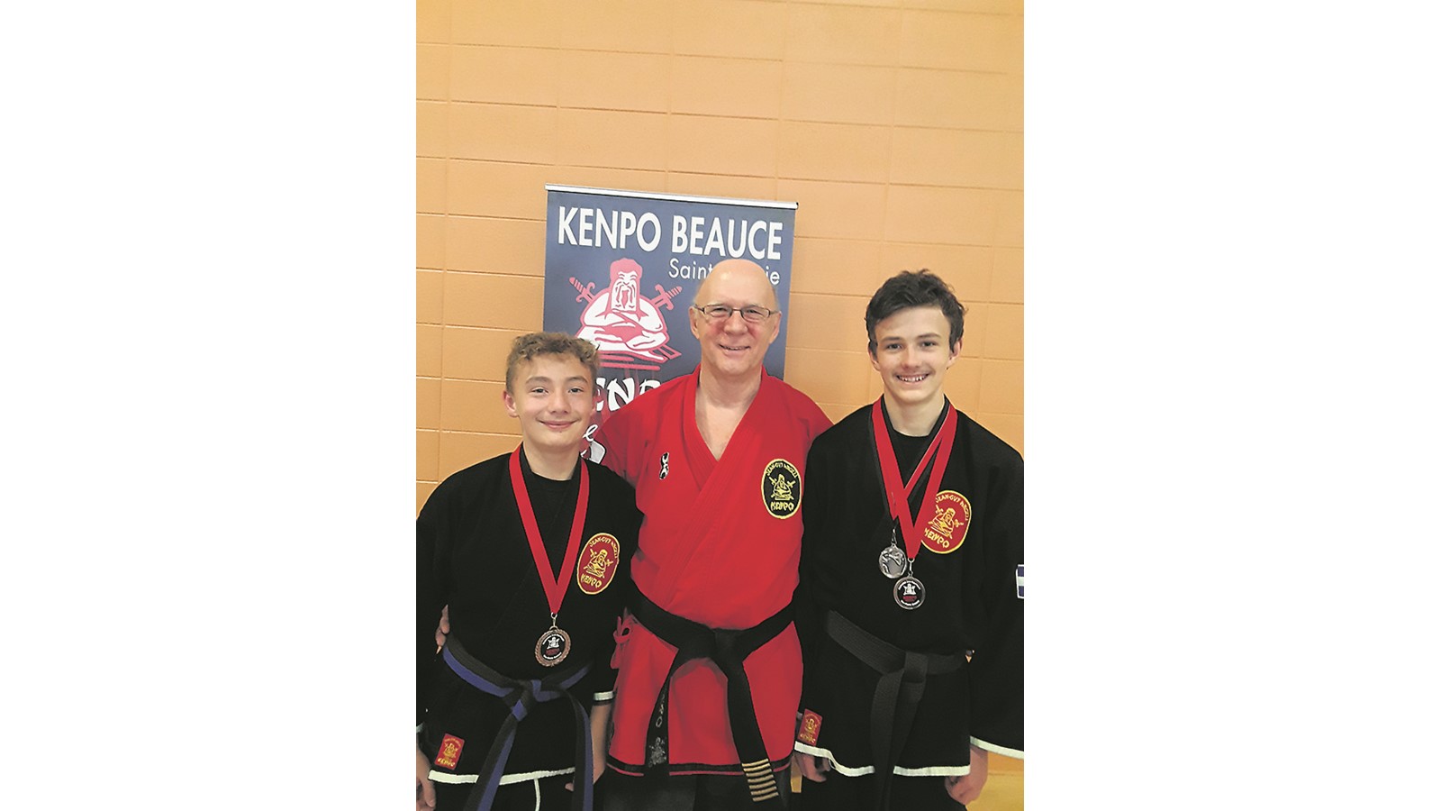 Le Senseï Guy Béliveau au centre, pose en compagnie des jeunes karatékas médaillés, Dilan Bouchard et Colin Picard