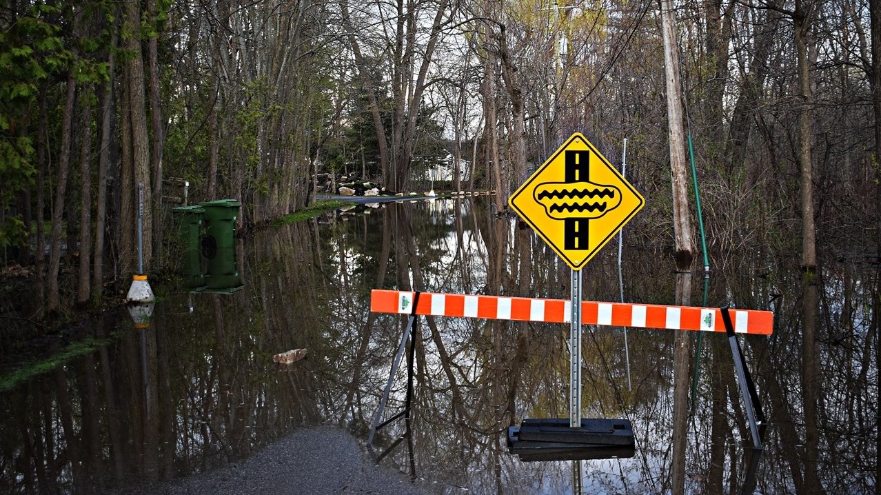 Flood waters cover the entrance to Jack Layton Park on May 4
