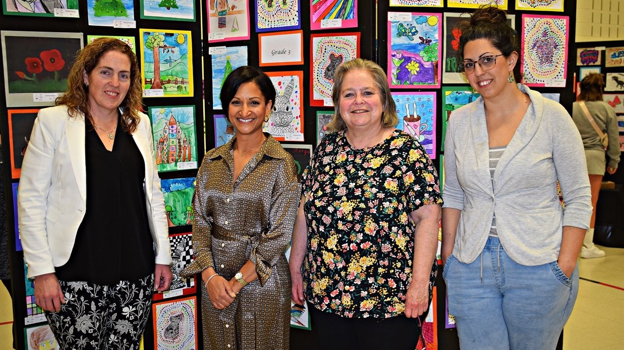 Students proudly dispaly their artwork at vernissage