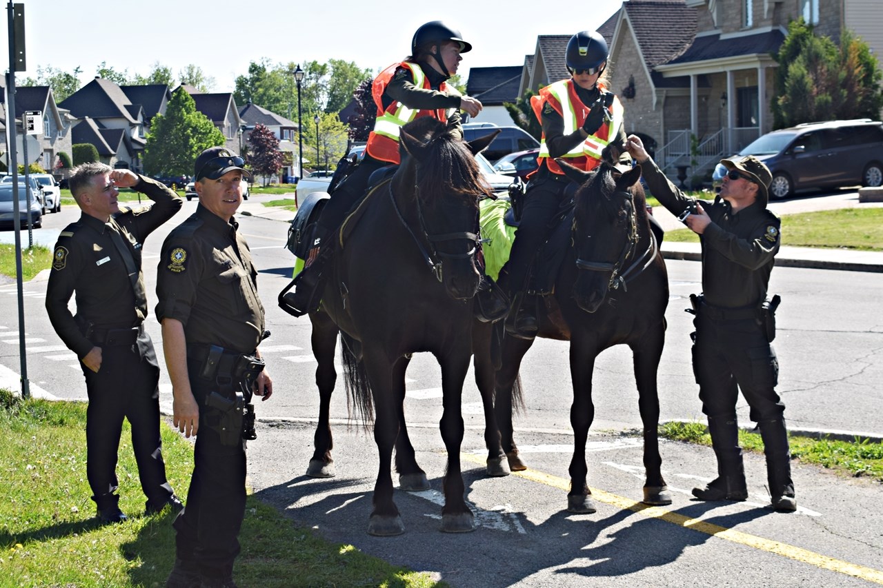 Sûreté du Québec mounted police officers participate in the search for Maurice Beauregard 82
and his dog in Pincourt on May 22 after they were reported missing the previous day.