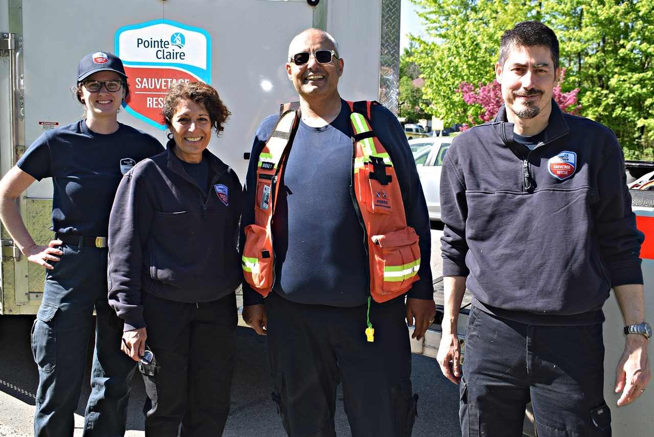 Members of the Pointe-Claire Volunteer Rescue Unit - From left to right, Kristen Hirsh-Pearson
(Search and Rescue Officer), Marianna Ferraiuolo (Training Officer), Bruno Demmerle
(Assistant Director) and Nader Mishariky (Director) stand next to their vehicle in Pincourt after
participating in the search and rescue effort to find Maurice Beauregard and his dog.