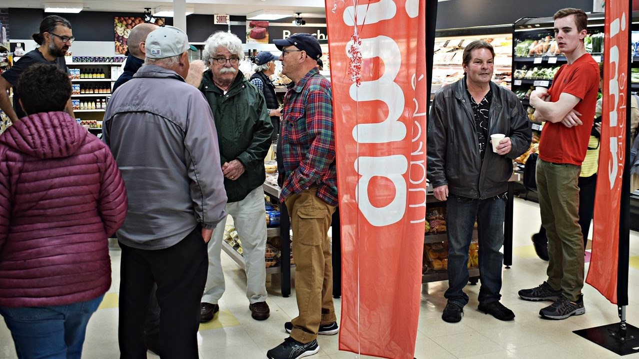 Residents check out the new Marché Ami grocery store in Ste. Anne de Bellevue yesterday evening and to celebrate its launch. The store officially opened this morning.