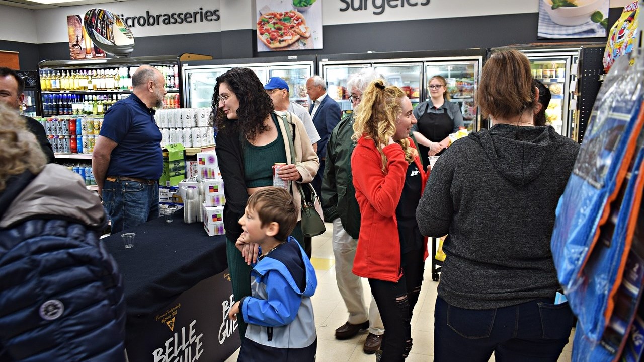Residents check out the new Marché Ami grocery store in Ste. Anne de Bellevue yesterday evening and to celebrate its launch. The store officially opened this morning.
