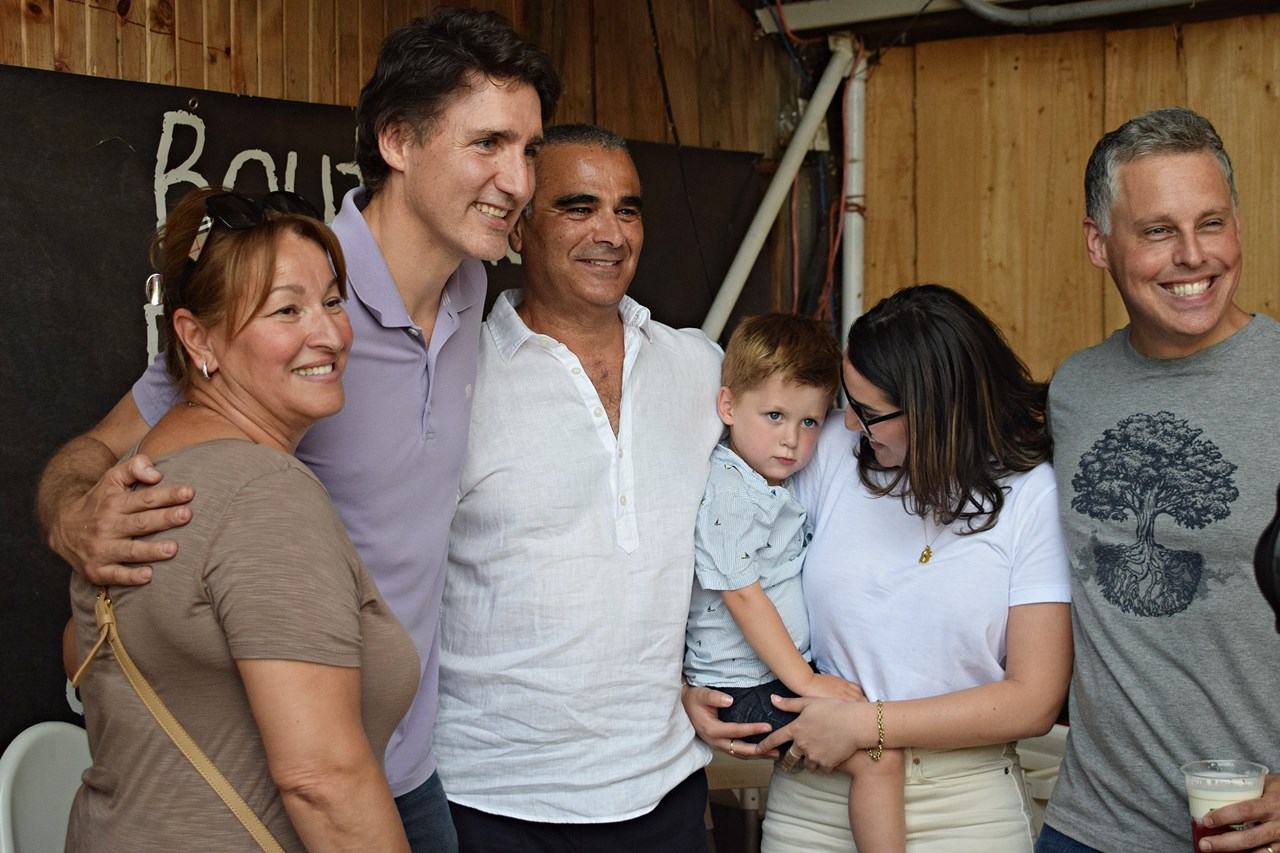 Prime Minister Justing Trudeau (second from left) and Vaudreuil-Soulanges MR Peter Schiefke (right) pose for a photo during an impromptu visit to pick strawberries Le Freme Quinn in Notre-Dame-de-l'Île-Perrot this afternoon, June 23.