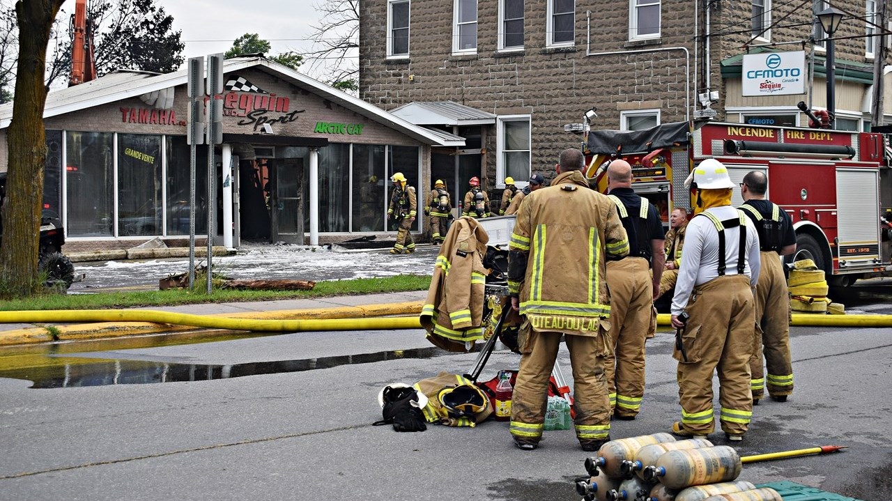 Firefighters at Séguin Sport in Rigaud this morning before the before the building was demolished.