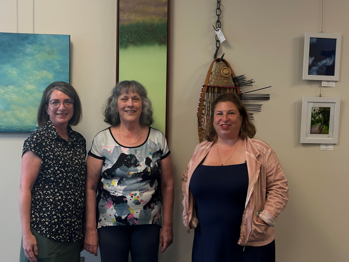 The three artists with some of their work