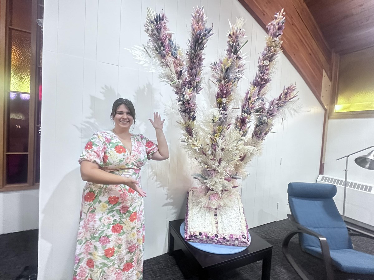 Catherine Desrochers in front of her flowers work