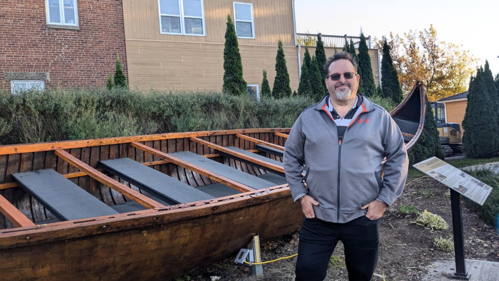Martin St-Jean poses in front of the canoe he built with his father Bernard in 1984