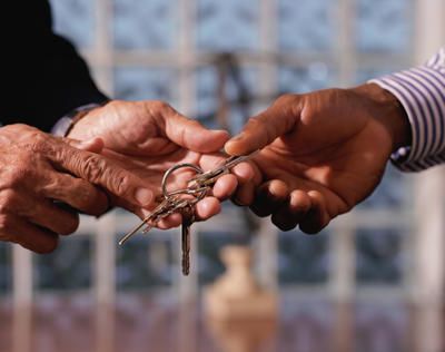 Men's hands exchanging keys