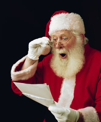 side profile of Santa reading a letter with a shocked expression