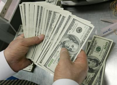 An employee of the Korea Exchange Bank counts U.S. one hundred dollar notes at the bank's headquarters in Seoul in this February 24, 2009 file photograph. The U.S. dollar may weaken and Treasury yields rise when Asian markets reopen on Monday August 8, 2011, though any selling in response to ratings agency S&amp;P's downgrade of the United States is likely to be tempered by the escalating crisis in the euro zone. The S&amp;P cut in the U.S. long-term credit rating by a notch to AA-plus is an unprecedented blow and results from concerns about the nation's budget deficits and climbing debt burden. It called the outlook "negative," signalling another downgrade is possible in the next 12 to 18 months. REUTERS/Jo Yong-Hak/Files (SOUTH KOREA - Tags: BUSINESS)