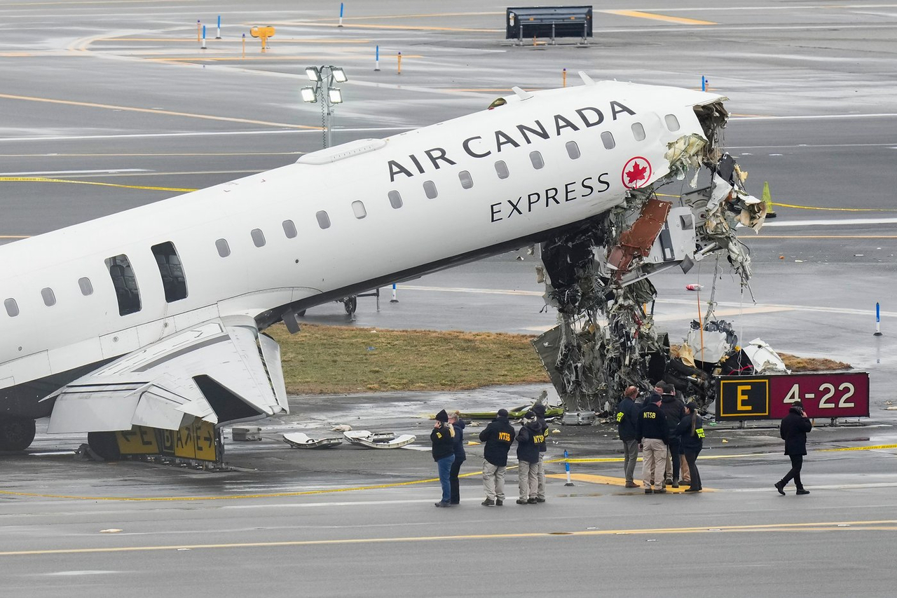 Des enquêteurs examinent l'avion après l'accident mortel à l'aéroport LaGuardia