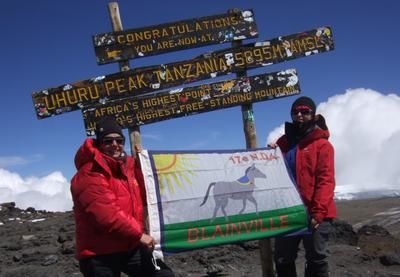 Monique Proulx brandit le drapeau des scouts au Kilimandjaro